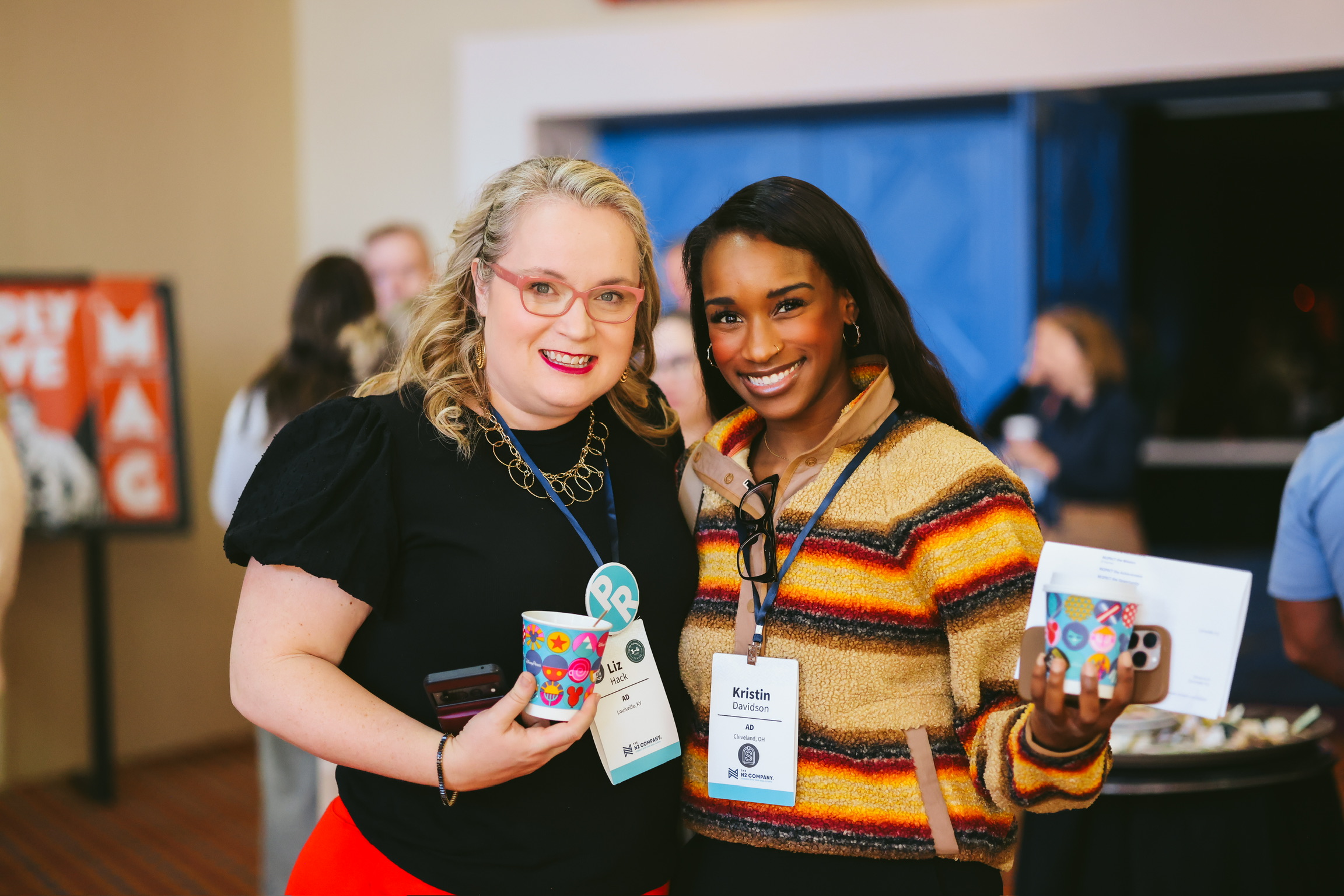 Two microfranchisees posing together at a conference