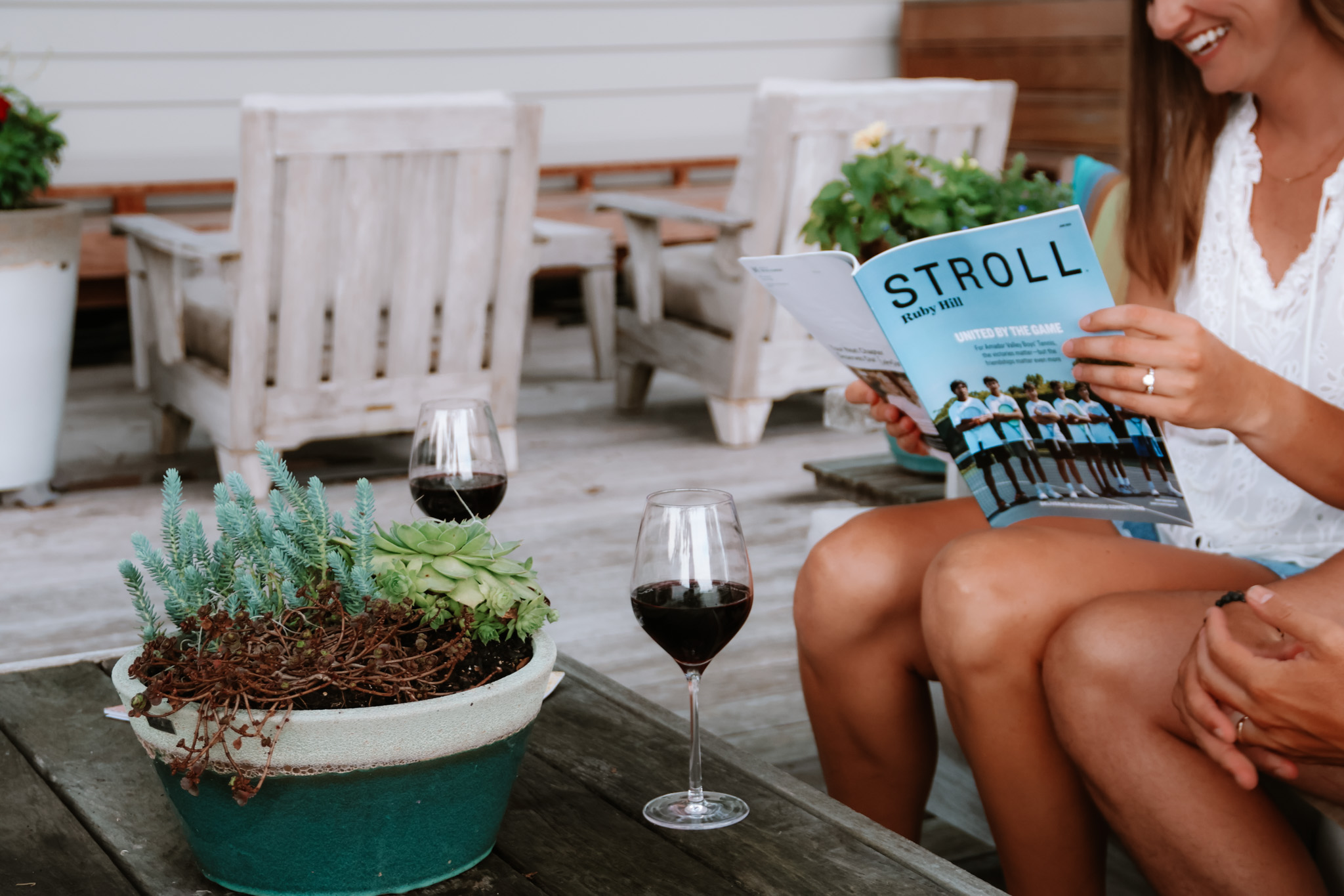 woman on back porch reading an issue of Stroll magazine