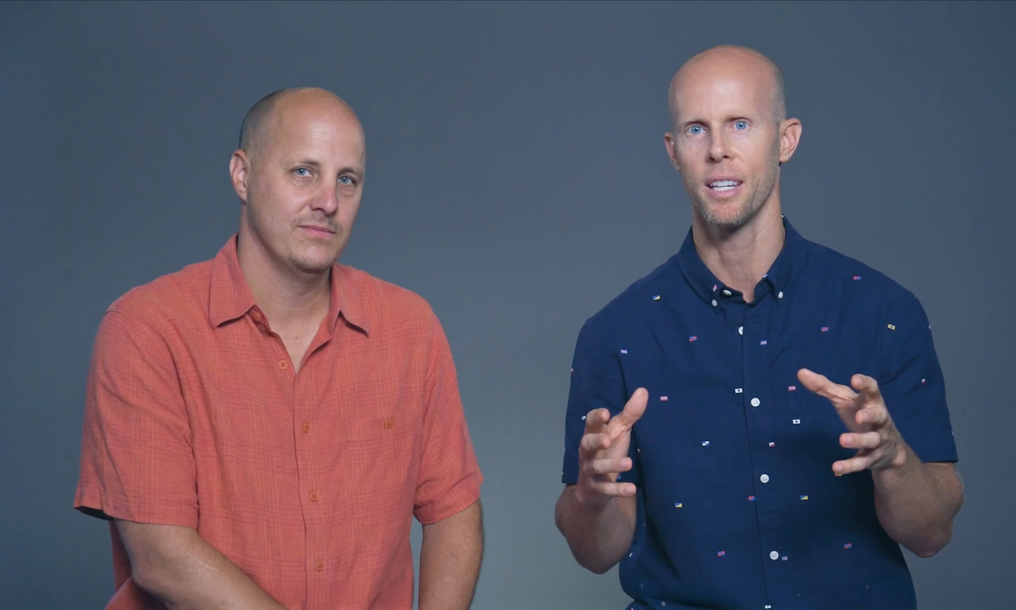 Two men speaking in a founder message video